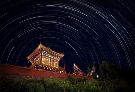 Temple at night illuminated with light from decorations