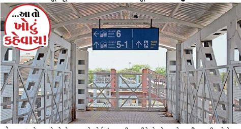Commuters jostle as the sign board shows the incomplete foot bridge ...