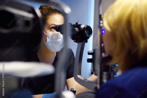 Slit Lamp eye examination with ophthalmologist. Patient during visit by oculist for exam of ...