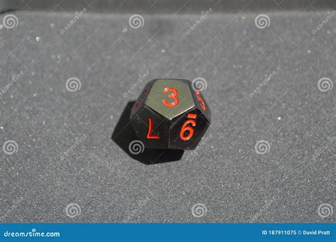 Black Metallic D12 Twelve Sided Dice on Foam Surface Stock Image ...