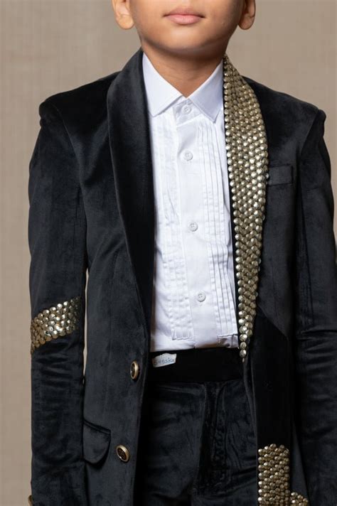 Luxurious Blackvelvet suit with studded embellishments, paired with a ...