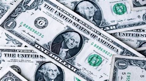 Collection of one-dollar bills featuring George Washington placed in a ...