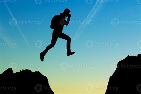 Silhouette of running man against the colorful sky. Silhouette of running man on sunset fiery ...