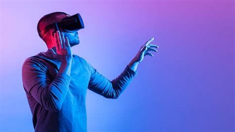 Man with futuristic device pointing up | Free Photo