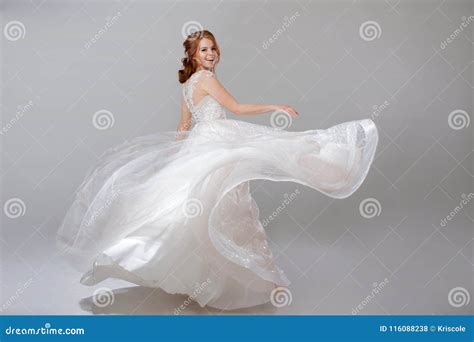 Young Woman Spinning in a Curvy Wedding Dress. Woman Bride in Lavish Wedding Dress. Light ...