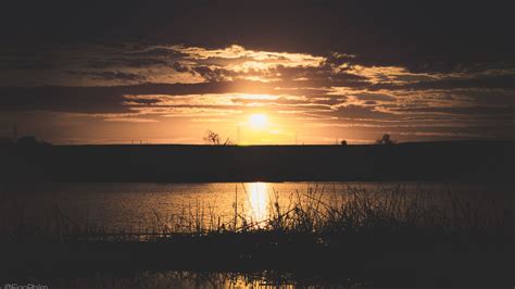 Download wallpaper 1600x900 river, grass, sunset, dark widescreen 16:9 ...
