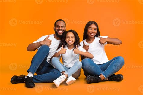 Family Approval. Portrait of smiling black family showing thumbs up ...