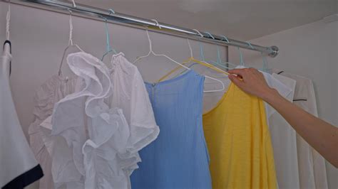 lady choosing blue and yellow shirts 23754473 Stock Video at Vecteezy