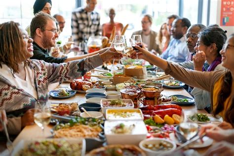 Group of diverse people are having lunch together | Premium Photo