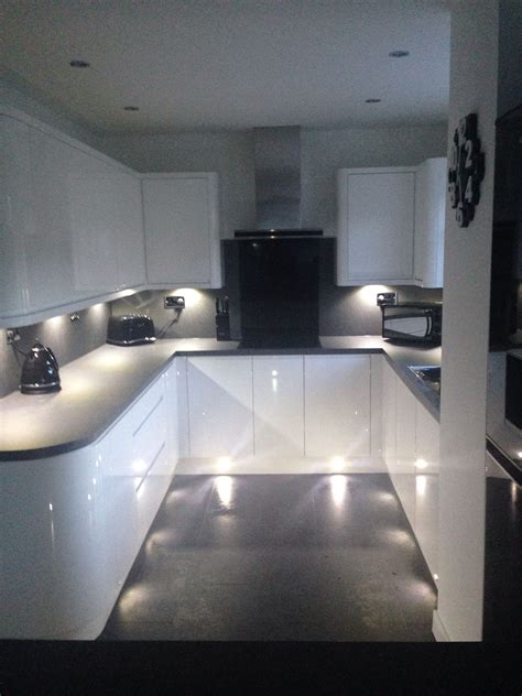 White gloss handless wren kitchen with curves, grey slate work top and ...