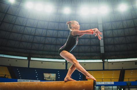 Girl Gymnast Jumping on Beam · Free Stock Photo
