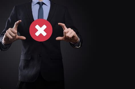 Рука держит значок, символ отмены, значок отмены. Отметка крестиком ...