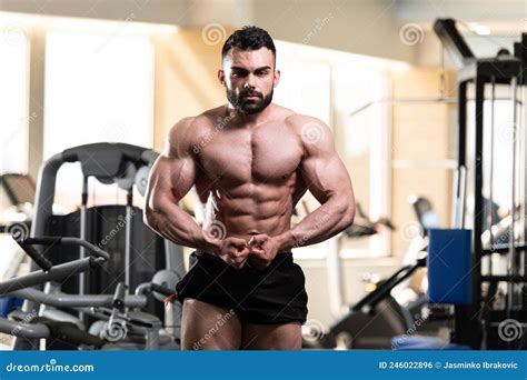 Handsome Body Builder Making Most Muscular Pose Stock Photo - Image of ...