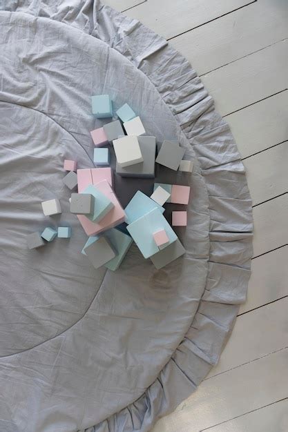 Multicolored toy cubes in pastel colors on the carpet in the children's ...