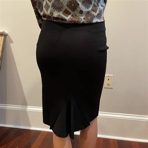 Black fitted but stretchy material skirt with accent... - Depop