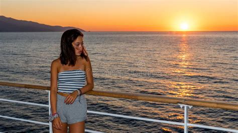 Asian Teen in Tube Top Standing on Deck of Ferry Looking at Sunset ...