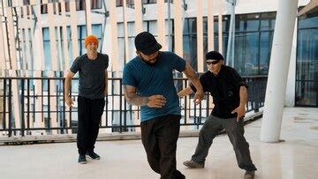 Hip hop team dance break dance while multicultural friend surround ...
