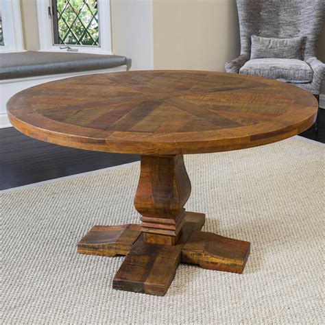The California vintage round mango wood dining table is an elegant ...