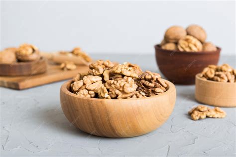 Fresh healthy walnuts in bowl on colored table background top view ...
