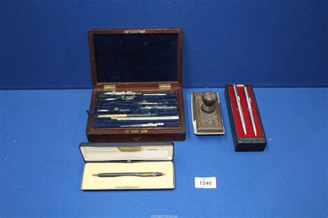 A cased set of a miscellaneous drawing instruments, two Papermate biro ...