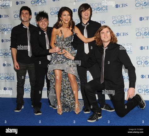 Singer Selena Gomez (C) and her band The Scene appear backstage with ...