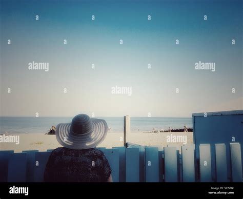 The woman in a hat at the beach Stock Photo - Alamy
