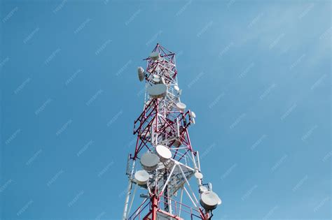 Low angle view of communications tower against blue sky | Premium Photo