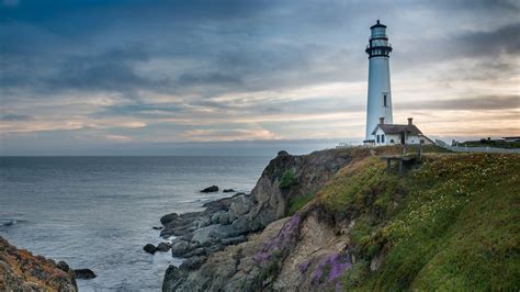 Download wallpaper 1366x768 lighthouse, building, rocks, sea tablet ...