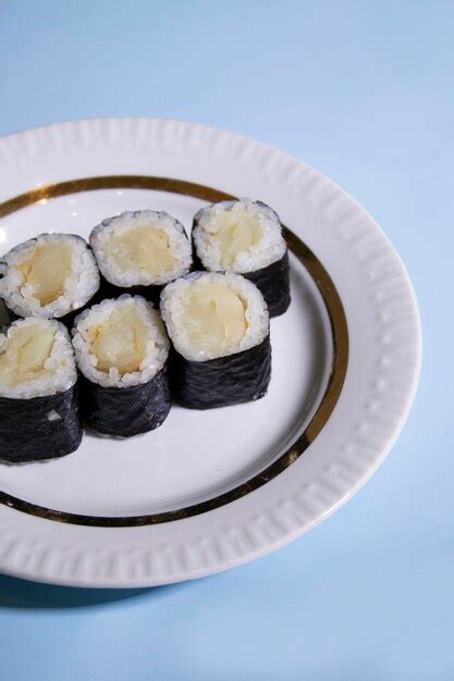A plate of maki sushi rolls with oilfish on blue background | Premium Photo