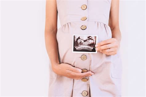 Premium Photo | Pregnant woman holding ultrasound baby image