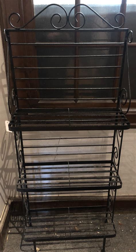 Lot - Three shelf baker's rack. (height: 59 inches, width: 24 inches, depth: 10 inches)