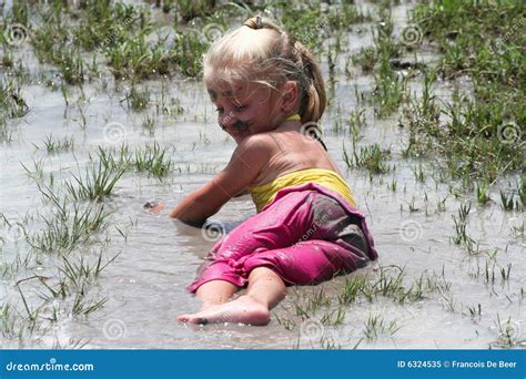 Girl lying in muddy water stock image. Image of kids, child - 6324535