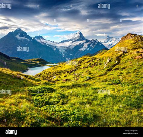 Wetterhorn and Wellhorn peaks over Bachsee lake. Colorful summer scene ...