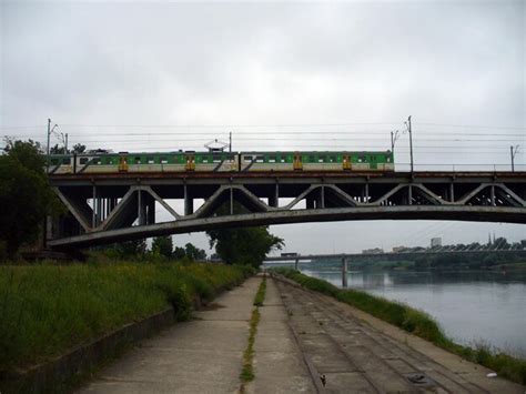 There is a vehicle on the bridge the prospect of a frog green train on ...