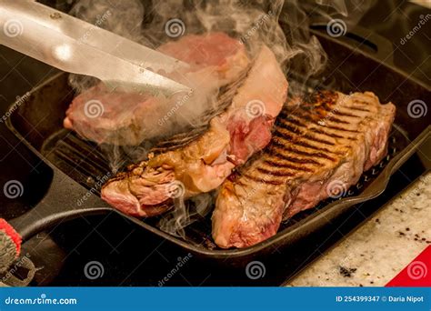 Grilling New York Beef Strip Sirloin Steaks on Cast Iron Grill Pan ...