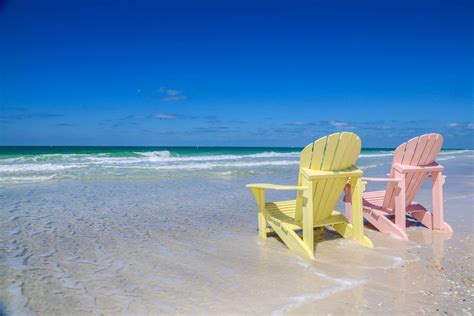 Download Florida Beach Pink And Yellow Sunchairs Wallpaper | Wallpapers.com