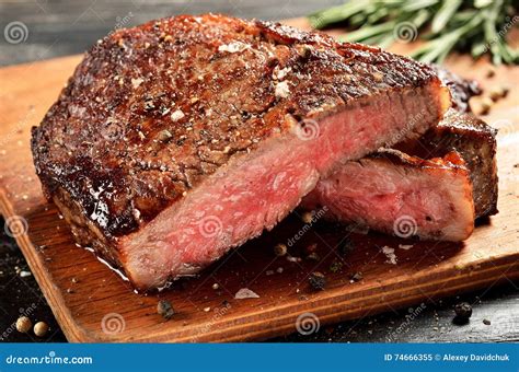 Medium Rare Ribeye Steak on Wooden Board, Selected Focus Stock Image ...