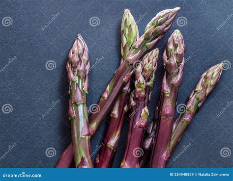 Asparagus on Dark Ructic Black Slate Background. Top View Fresh Purple ...