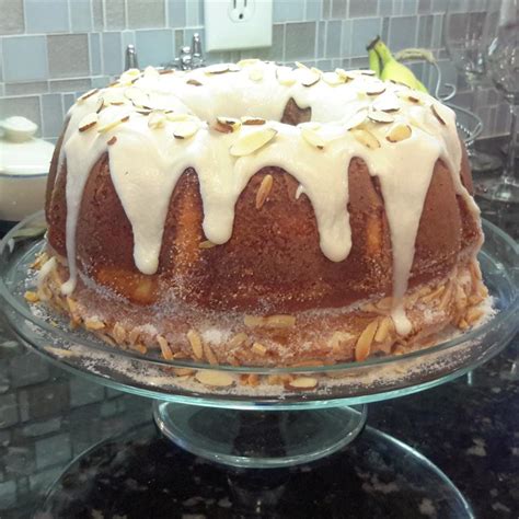 side view of Vaselopita - Greek New Years Cake dusted with powdered sugar with a slice cut out of it
