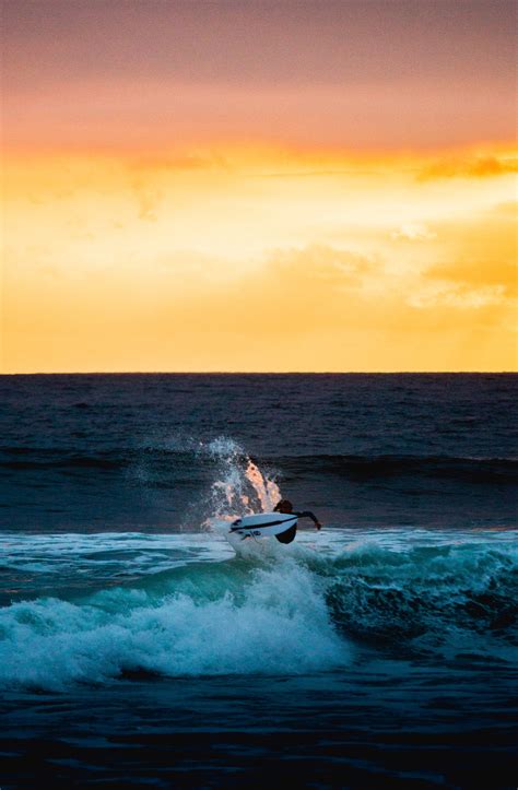 Download wallpaper 2197x3353 surfer, surfing, wave, horizon, sunset hd ...