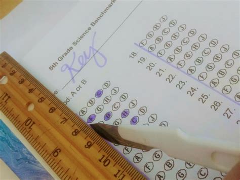 Become a human scantron machine! Use your hole punch and create a master answer key sheet to ...