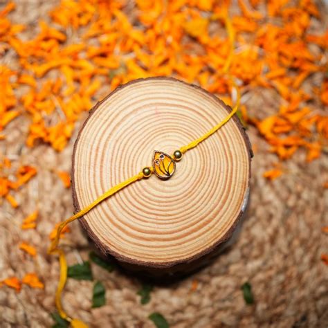 Send Golden Glow Rakhi with Besan Laddu Online