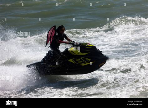 A woman performing a stunt on her Sea-Doo Spark with the words “Make Waves sales event”