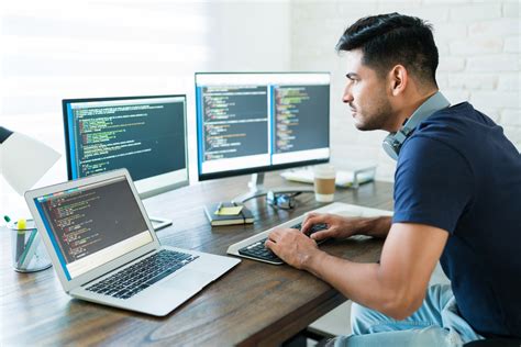 Handsome Young Male Programmer Coding At Desk | Fernando Raymond