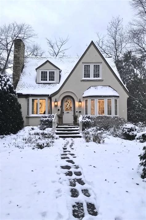 https://buildgreennh.com/wp-content/uploads/2024/10/7-front-view-of-a-snowed-in-white-cottage-house-lots-of-snow-on-multi-pitch-roof-bay-windows-with-white-trim-entrance-with-steps-front-yard-snowed-768x1152.jpg