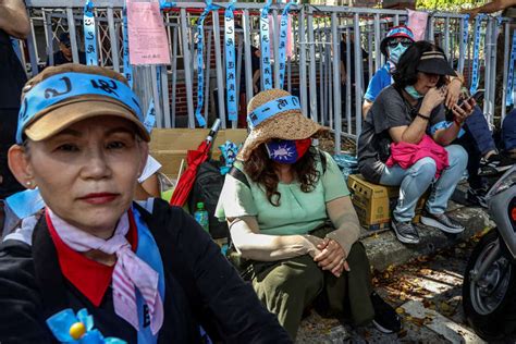 Supporters of Taiwan's main opposition party the Kuomintang (KMT) sit ...