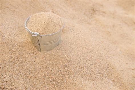 Bucket in the sand pile | Premium Photo