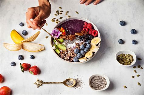 Premium Photo | A woman is eating an acai bowl with fresh fruits for breakfast with banana ...