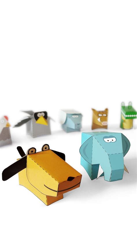 some paper animals are on a white surface and one is blue, the other is ...