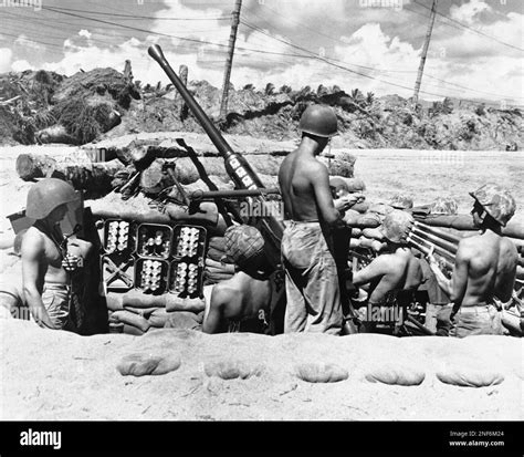Members of this 40-mm gun crew on Bougainville Island in the Solomons ...